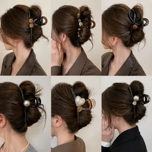 Detailed view of six elegant pearl hair claw clips styles for styling on model's hair.
