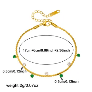 Detail view of gold-plated bracelet featuring green and white gems with size specs