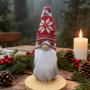 Detailed close-up of a Christmas gnome decoration with a red knitted snowflake hat.