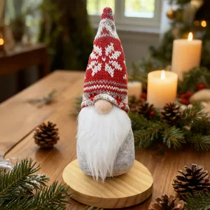Detail view of a Christmas gnome with a red knitted snowflake hat on a wooden base
