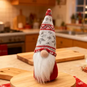 Close-up of a festive Christmas gnome with a knitted snowflake hat on a wooden tray