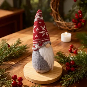 Close-up detail of a festive Christmas gnome with a red knitted snowflake pattern hat.