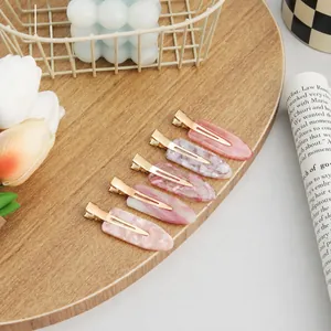 Elegant cherry blossom pink no-crease hair clips set on a aesthetic wooden background.