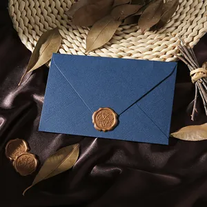 Close-up of a vintage navy blue linen envelope with a gold 'For You' wax seal
