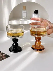 Close-up of elegant vintage glass goblets with unique spherical stems on a table