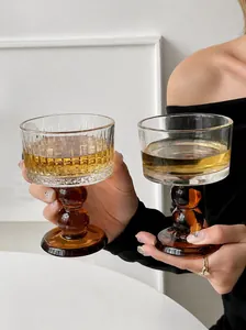 Macro view of vintage-style glass goblets featuring amber-colored stacked ball stems.