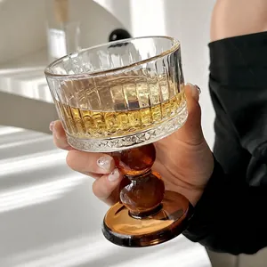 Elegant vintage style ribbed glass goblet with amber pedestal base for wine and champagne