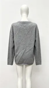 Back view of a grey oversized knit sweater on a mannequin showing texture and loose fit