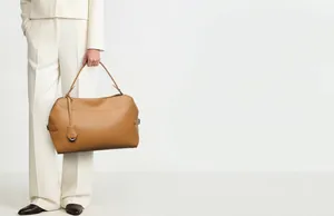 Professional view of a large brown leather tote bag for office and commuter style.