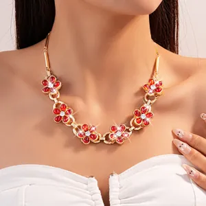Detailed close-up of a luxury vintage court style necklace with red crystal flowers.