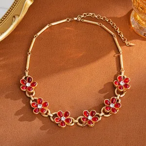 Elegant gold-tone chain necklace with vintage red flower pendants and crystal accents