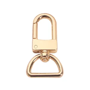 Polished gold metal swivel lobster clasp with D-ring for bag strap replacement.