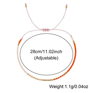 Adjustable pink and orange beaded bracelet with gold accents, 28cm length, 1.1g weight.