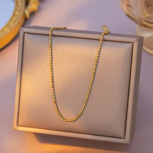 Elegant gold bead chain necklace in stainless steel displayed on a jewelry box