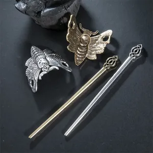 Close-up of vintage moth hairpins with skull details and matching metal sticks