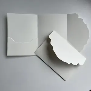 Gros plan d'un ensemble de cartes d'invitation de mariage blanc avec bords festonnés