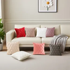 Set of textured plush throw pillow covers with quilted geometric patterns on a cream sofa
