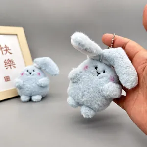 Adorable light blue fluffy lop-eared bunny plush keychain used as a bag charm accessory