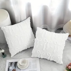 Elegant white plush pillow covers featuring quilted bow embroidery for sofa decor