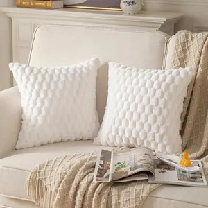 Soft textured white honeycomb quilted plush throw pillow covers displayed on a cozy beige sofa