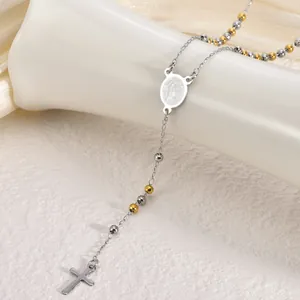 Detail view of stainless steel rosary necklace with cross and Miraculous Medal pendant.