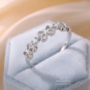 Close-up macro detail of an elegant silver butterfly ring featuring sparkling zircon stones