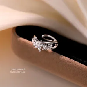 Detailed macro view of a sterling silver star-shaped ring on a velvet stand