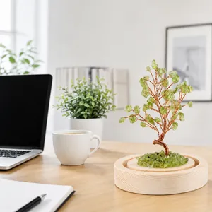 Detailed lifestyle view of a green crystal money tree on a wooden base.