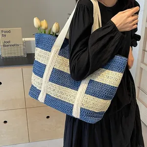 Large striped straw woven tote bag for beach vacations with comfortable shoulder straps.