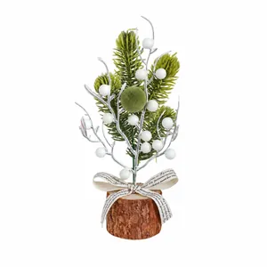 Miniature desktop Christmas tree decoration with white berries and rustic wooden base