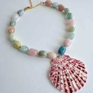 Close-up of natural stone bead necklace featuring a vibrant pink striped shell pendant.