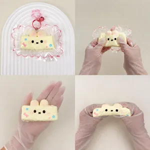 Detailed view of cream bunny squishy toy being squeezed to show soft slow rebound