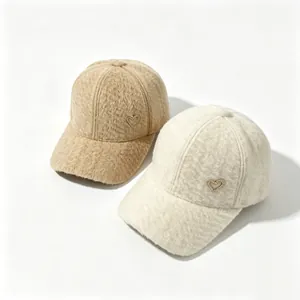 Close-up of warm alpaca fleece baseball caps with rhinestone heart detail