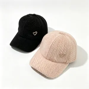 Detailed view of the fuzzy alpaca wool texture and rhinestone heart on stylish baseball caps