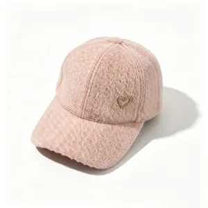Macro view of pink fuzzy alpaca wool baseball cap featuring a sparkling rhinestone heart