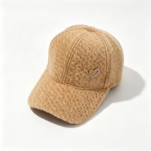 Detail of fuzzy brown alpaca wool baseball cap with sparkling rhinestone heart.