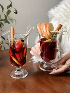 Close-up of mulled wine in an elegant glass with festive winter fruit garnishes
