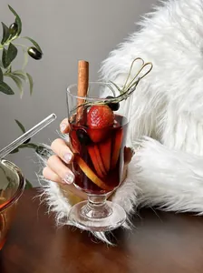 Close-up of tall glass filled with mulled wine and fresh fruit slices