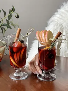 Detailed view of two elegant mulled wine glasses in a cozy winter setting