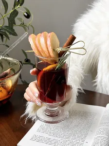 Close-up of an elegant stemware glass filled with festive mulled wine and aromatic spices