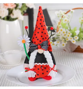 Detailed view of ladybug-themed plush gnome doll with daisy and red polka dot hat.