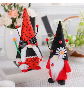 Detail of ladybug themed plush gnomes featuring red and black polka dot hats and daisy accents.