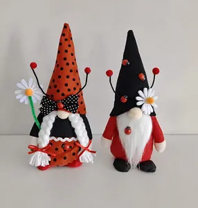 Front view of two ladybug-themed holiday gnomes with polka dot hats and white braids
