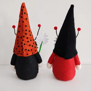 Detailed back view of two decorative plush ladybug gnomes for holiday home ornament