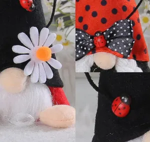 Detail view of ladybug-themed gnome featuring plush textures and decorative daisy