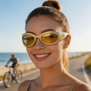 Close-up detail of women's Y2K cycling sunglasses with yellow lenses and beige frame