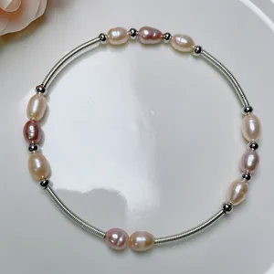 Detail of handmade freshwater pearl wire-wrapped bracelet with silver beads