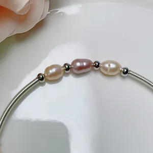 Close-up of elegant freshwater baroque pearls on a silver-tone coiled wire bracelet