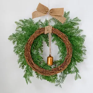 Rear view of Christmas cedar wreath with burlap bow and golden bell detail