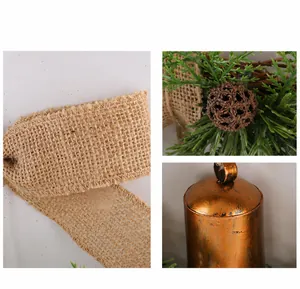 Macro detail view of Christmas wreath burlap bow, pinecones, and vintage bronze bell